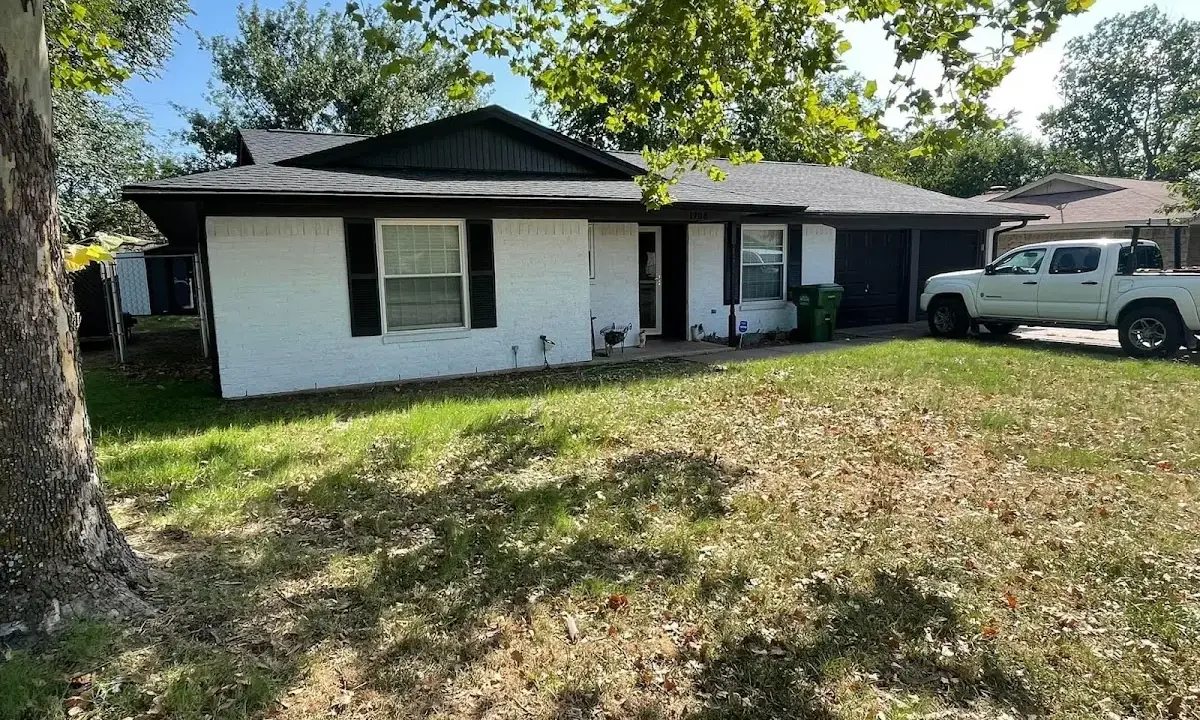 Professional roofing crew working on a residential roof in Chestnut Ridge